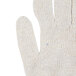 A close up of a pair of Cordova medium weight natural polyester/cotton work gloves with blue trim on the thumb.