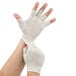 A pair of hands putting on Cordova fingerless gloves.