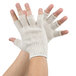 A person's hands wearing white gloves.