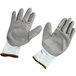 A pair of Cordova extra small white gloves with gray palm coating.