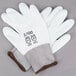 A pair of small white Cordova gloves with white polyurethane palms.