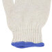 A white knitted glove with blue trim.