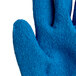 A close up of a Cordova blue and white cut-resistant glove with latex palm coating.