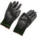 A pair of green Cordova Monarch work gloves with black polyurethane palms.