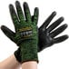 A pair of extra small Cordova Monarch green gloves with black polyurethane palms.