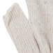 A close up of a white knitted fingerless glove.