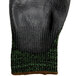 A pair of black and green Cordova Monarch gloves with green trim.