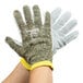 A pair of Cordova Power-Cor Max cut-resistant gloves with camo and yellow trim on a white background.