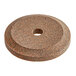 A circular brown stone with a hole in the middle.
