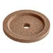 A brown circular granite stone with a hole in the middle.