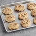 Pre-formed Michael's vegan oatmeal raisin cookie dough on a baking sheet.