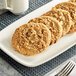 A plate of Michael's pre-formed vegan oatmeal raisin cookies on a white surface.