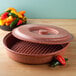 A red HS Inc. tortilla server with colorful peppers.