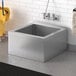 A Steelton stainless steel mop sink with a bucket and mop inside.