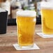 Two Acopa Select English Pub glasses of beer on a table.