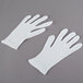 A pair of white Cordova Medium Weight Polyester/Cotton Reversible Lisle Gloves.