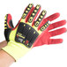 A pair of yellow Cordova heavy duty work gloves with red TPR reinforcements and a red sandy nitrile palm coating.