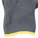A gray and yellow Cordova knitted glove with a yellow trim.