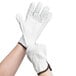 A pair of Cordova white leather driver's gloves with brown trim on the forefingers.