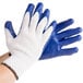 A pair of small Cordova work gloves with blue latex palm coating on a white background.