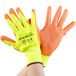 A pair of Cordova yellow gloves with orange polyurethane palms.