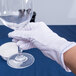 A hand in a Cordova small inspector's glove holding a wine glass.