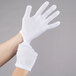 A hand wearing white Cordova Inspector's Gloves.