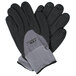 A close-up of a pair of Cordova Conquest Max black and grey gloves with grey nitrile dots.