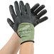 A pair of hands wearing black Cordova Power-Cor cut-resistant gloves with black foam nitrile palms.