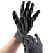 A pair of gray Cordova warehouse gloves with black nitrile palms.