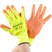 A pair of Cordova yellow gloves with orange palm coating.