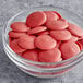 A bowl of red candies with pink centers.