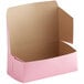 A pink Baker's Mark bakery box with the lid open.