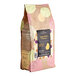 A package of Valrhona Passion Fruit Inspiration Couverture Feves with a yellow and pink polka dot pattern.