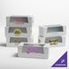 A stack of Baker's Lane white customizable bakery boxes with different logos on them.