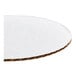 A round, white, corrugated grease-resistant cake circle.