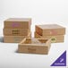A group of Baker's Lane brown pie boxes with custom purple and pink logos on display.