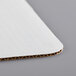 A white Baker's Mark corrugated cake pad.