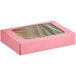 A pink Baker's Mark bakery box with a clear window.