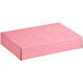 A pink Baker's Mark bakery box with a black lid.