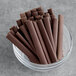 A bowl of Valrhona dark chocolate sticks.