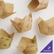 A group of Baker's Lane brown paper tulip-shaped baking cups with black text on the sides.