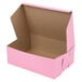 A pink Baker's Mark cake box with the lid open.