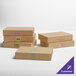A group of Baker's Lane brown donut boxes with different designs and blue and purple writing.