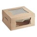 A brown Baker's Mark cake box with a clear window.