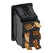 A black electrical switch with gold colored connectors.