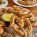 A plate of SuperPretzel whole grain soft pretzels with sauce on a table.
