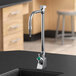 A Delta laboratory faucet with a gooseneck spout and TECK lab handles on a black counter.