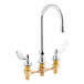 A chrome Delta deck-mount faucet with dual brass blade handles.