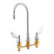 A Delta chrome deck-mount lavatory faucet with two curved brass blade handles.